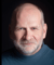 Darius James headshot - a white man with a grey beard and a kind face.